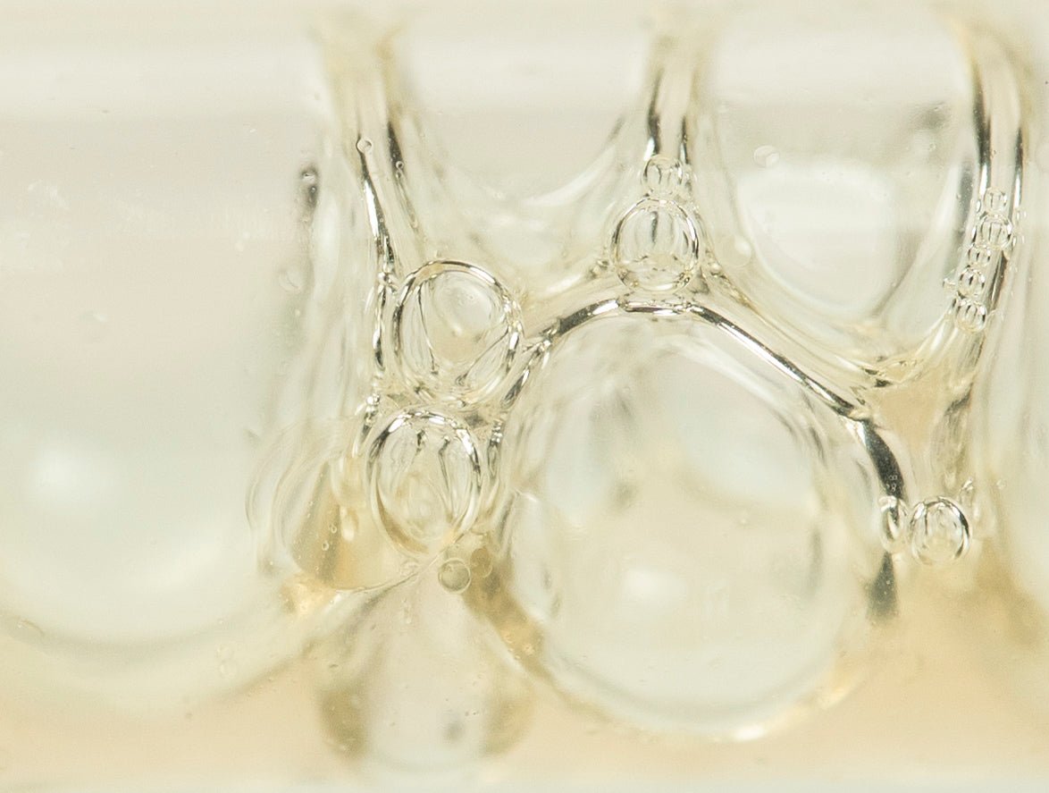 Close-up of the clear, lightweight texture of All-Over Radiance Body Essence