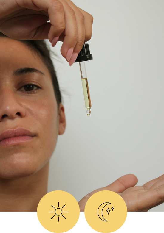 someone holds a pipette filled with Day Light Face Oil, there are also two icons, one of a sun and one of a moon that indicates this is for daytime and nighttime use