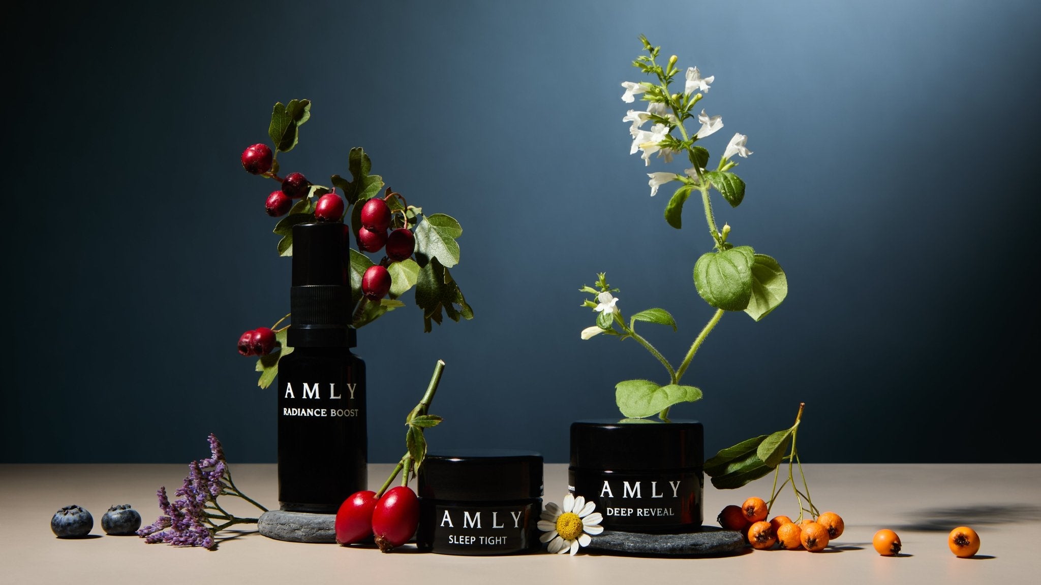 Hero Discovery Kit minis arranged with berries, wildflowers and botanicals on a dark blue background