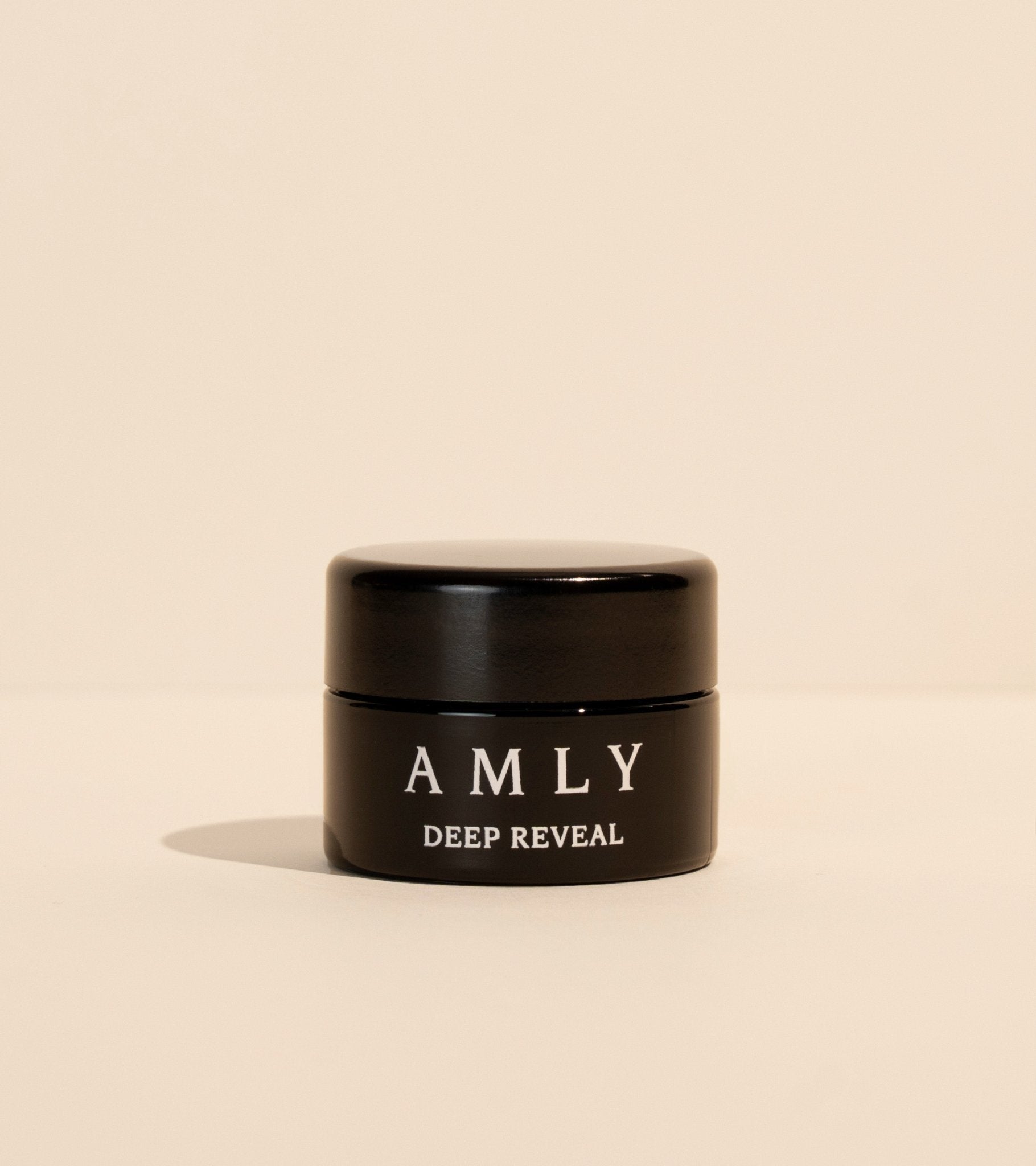 Deep Reveal Cleansing Balm jar from the Sleep Night Kit on a beige background