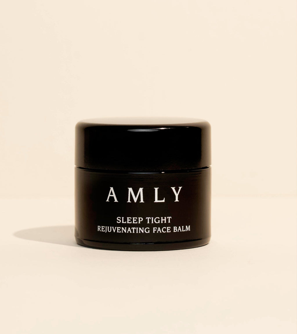 AMLY Sleep Tight Rejuvenating Face Balm in a black glass jar on a soft beige background